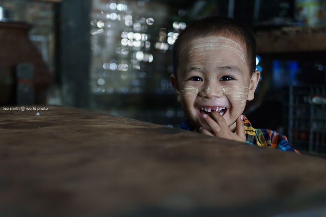 Leo Smith PhotoVideo | World Photo: A mother asks her son to pose for a photo at Hsi Paw Train Station