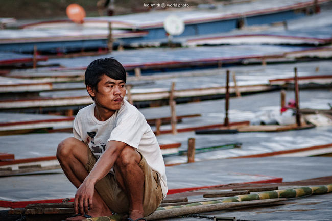 Leo Smith Photo Video | World Photo: A man ties up the boats on the Mekong River, Laos