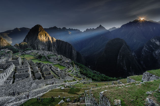 Leo Smith World Photo: Peru Photos and Prints -- Sunrise bursting over the mountains and casting a shaft of light onto Huayna Picchu, Machu Picchu