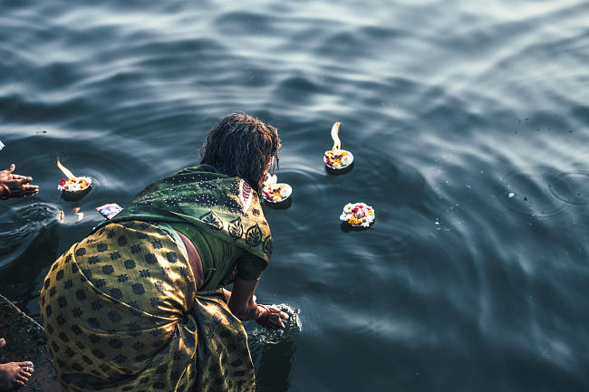 Leo Smith Photo Video: Leo Smith World Photo: Travel, Documentary & Landscape Photography and Video -- morning prayer candles in the Holy Ganga (Ganges) River, Varanasi