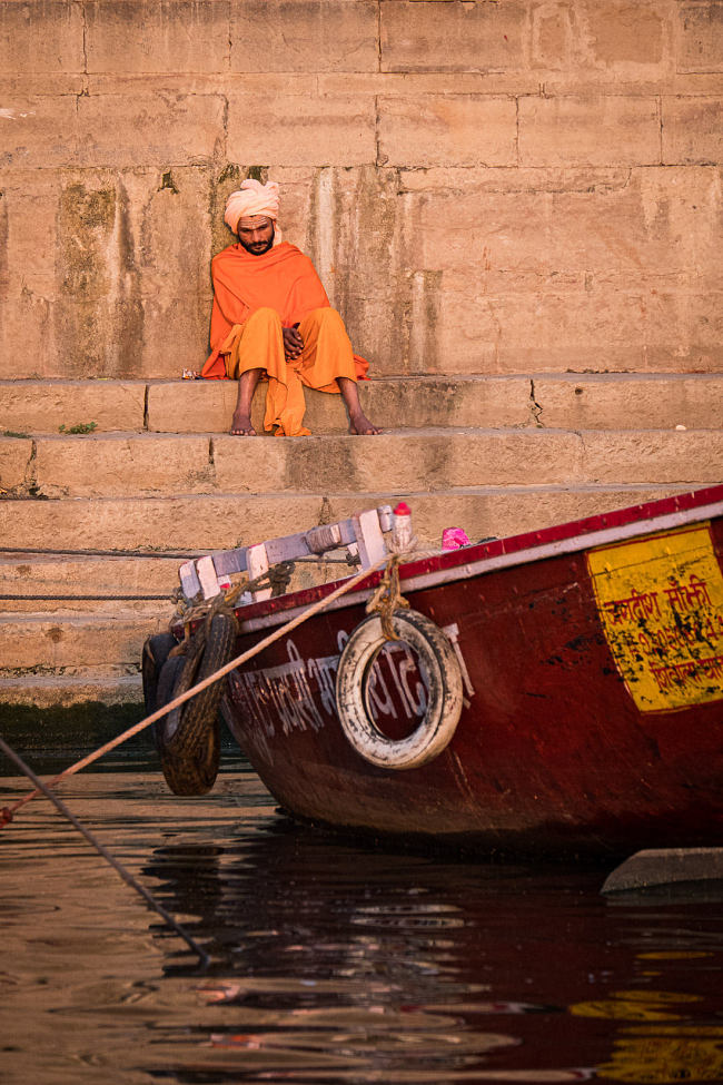 A man rests on the ghats at sunrise, Varanasi, india