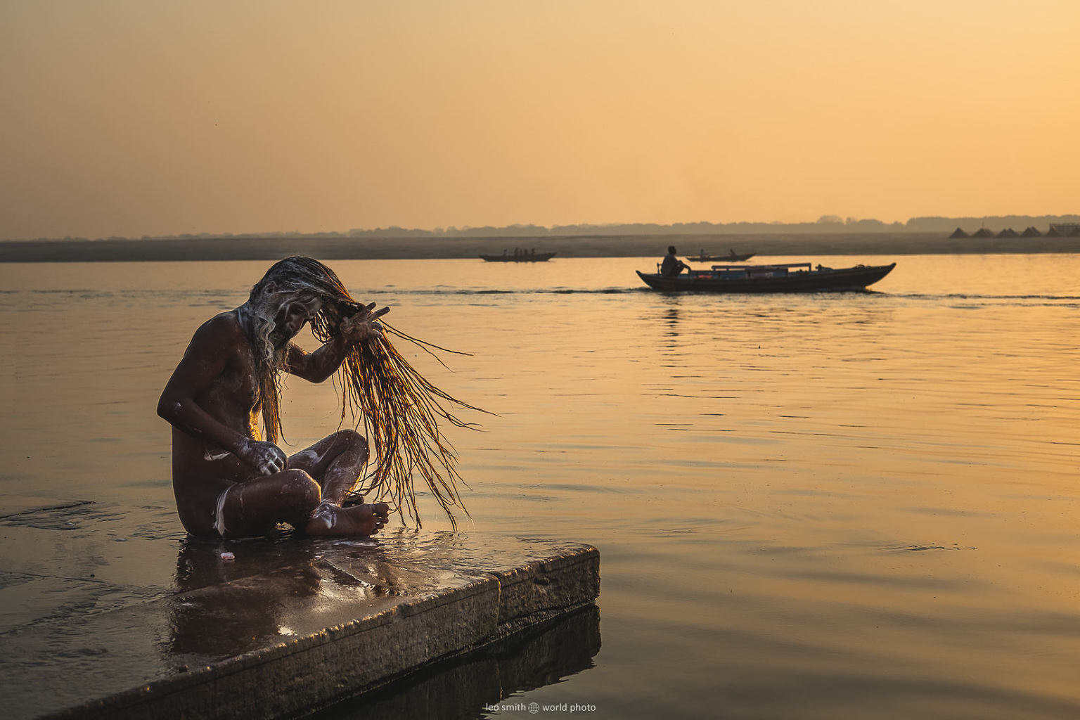 Leo Smith PhotoVideo | World Photo: A man performs his morning prayer rituals on the edge of the River Ganga (Ganges) at dawn, Varanasi, India