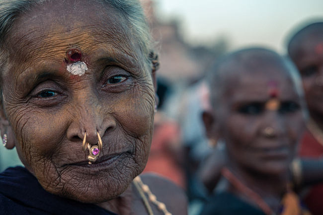 A woman waits to board her boat on the ghats in Varanasi, India - Leo Smith Photo Video: travel, Documentary & Landscape Photography and Video