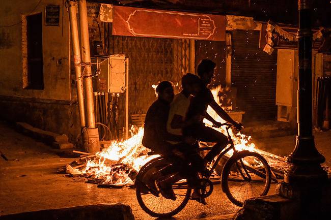 Fires burn on the streets of Varanasi, India, during Holika - photo by Leo Smith Photo Video